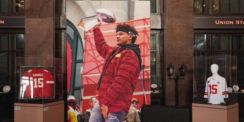 A poster of Patrick Mahomes holding up the Super Bowl with Kansas City Chiefs jerseys on both sides.